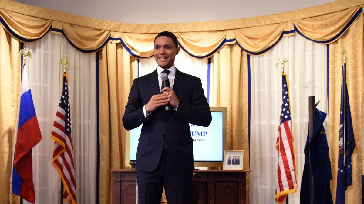 Trevor Noah at "The Daily Show Presents: The Donald J. Trump Presidential Twitter Library," designed to look like the Oval Office.