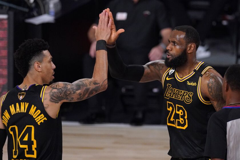 Los Angeles Lakers' Danny Green (14) and LeBron James (23) celebrate a basket by James.
