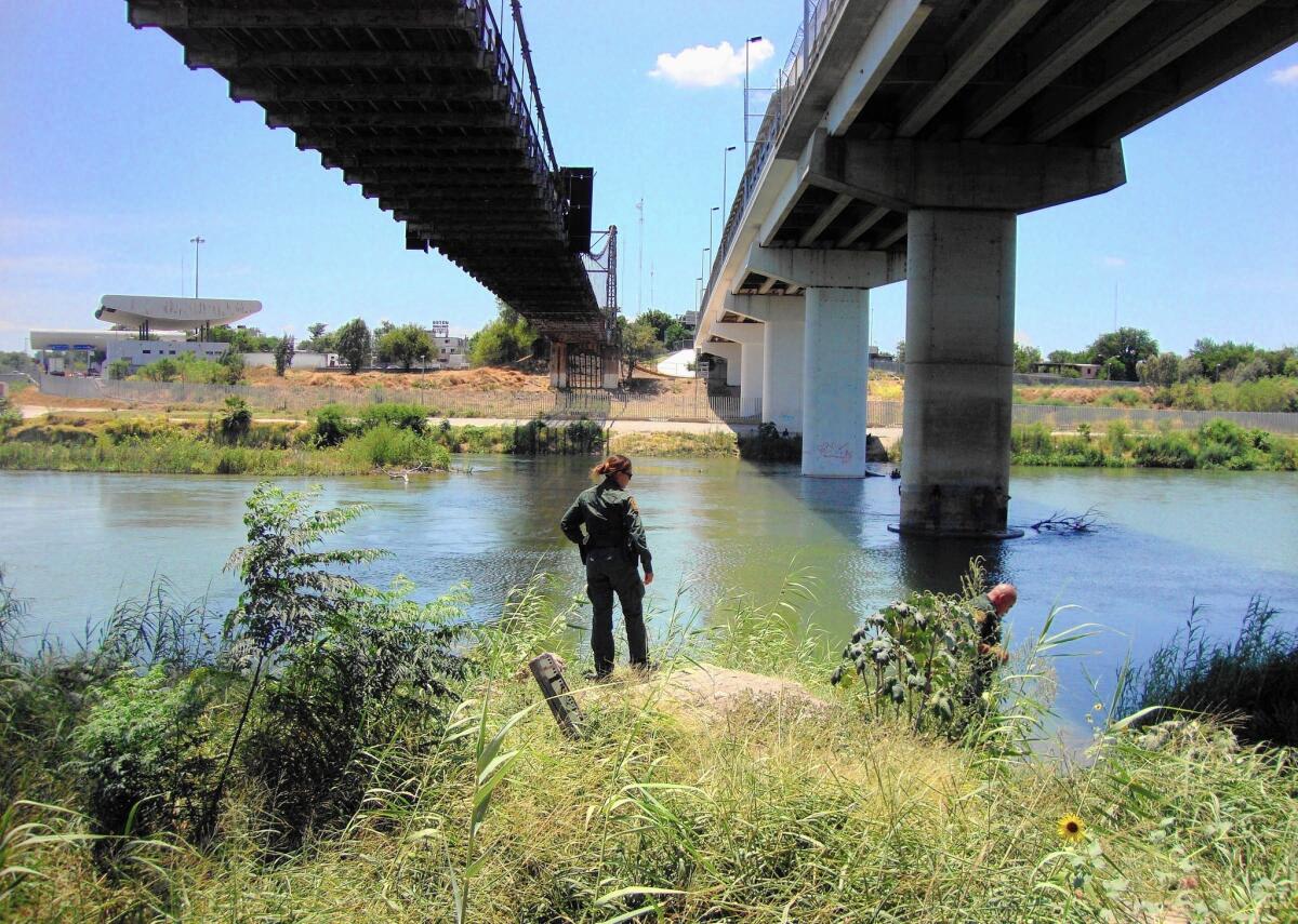 Border Patrol Agent Erica Sanchez, 33, searches for immigrants on the banks of the Rio Grande near Roma, Texas.