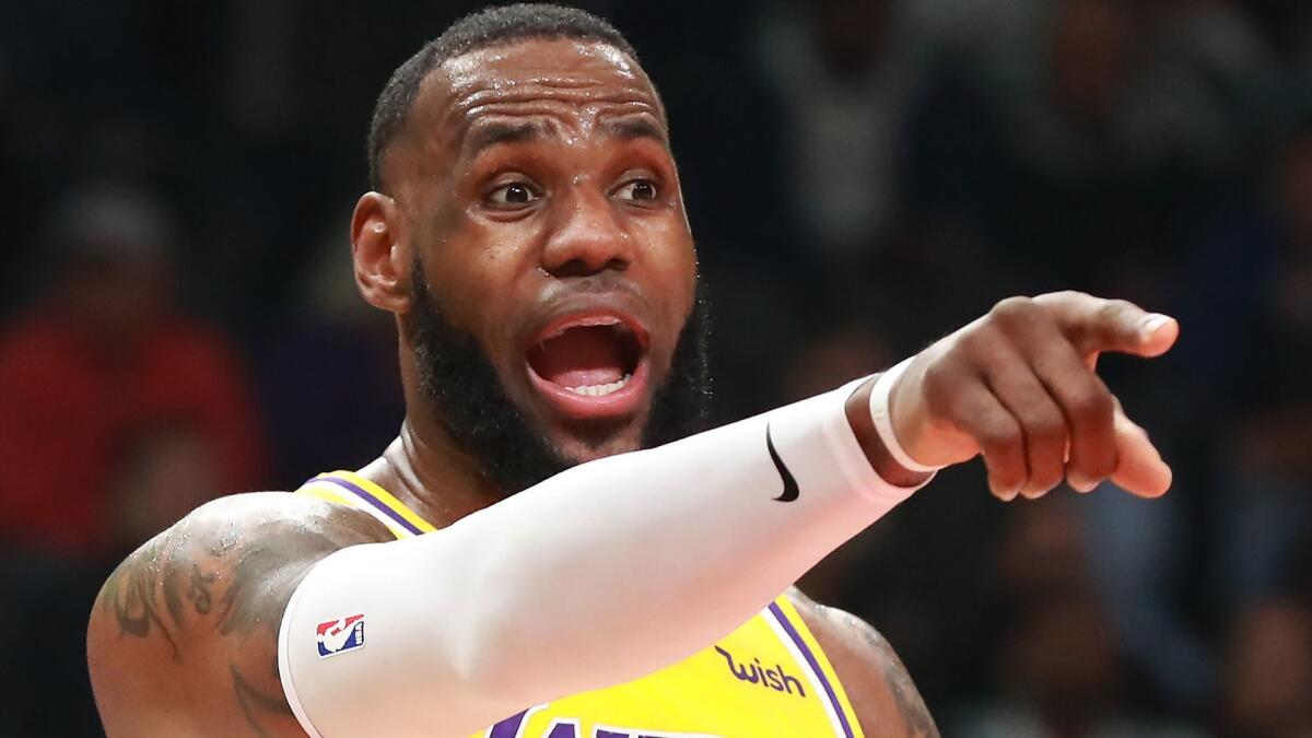 Lakers forward LeBron James directs his team during the 117-113 loss in Atlanta on Tuesday night.