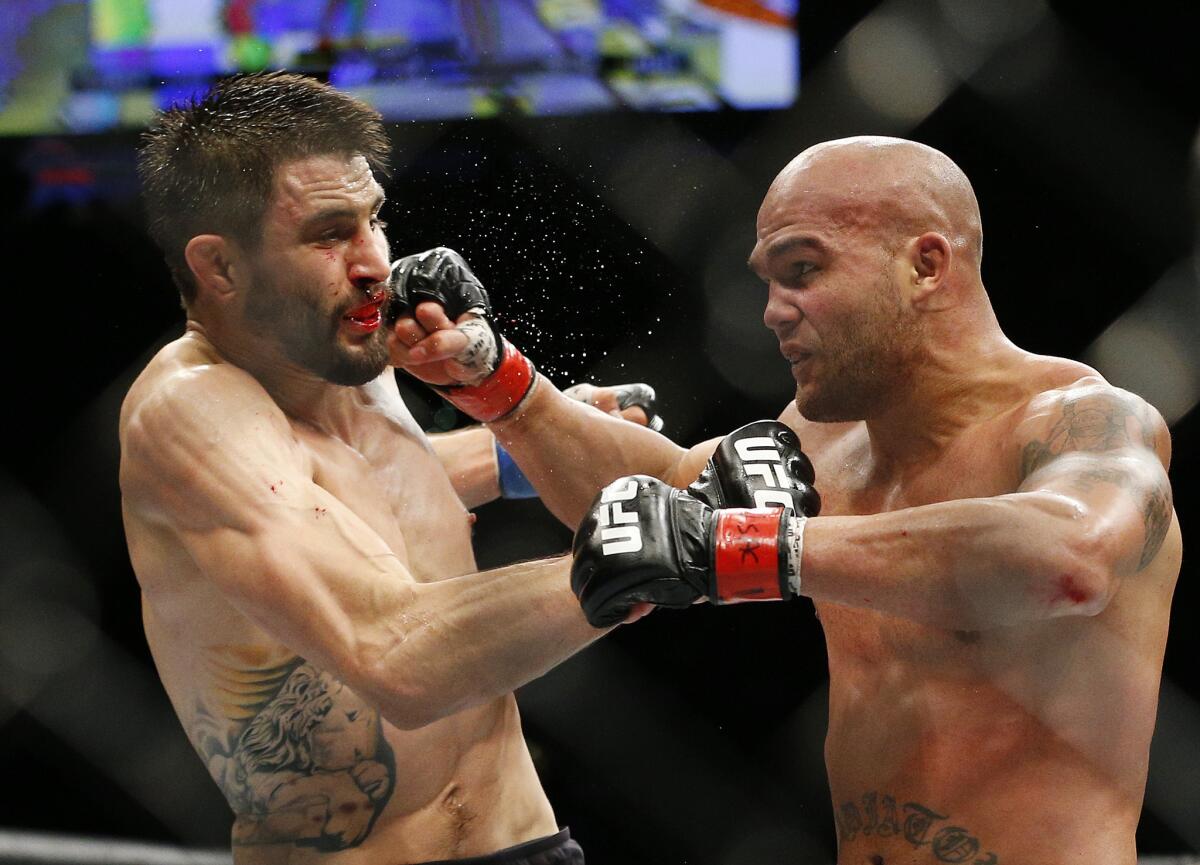 Robbie Lawler, right, lands a punch to the jaw of Carlos Condit during their UFC welterweight championship bout on Jan. 2.