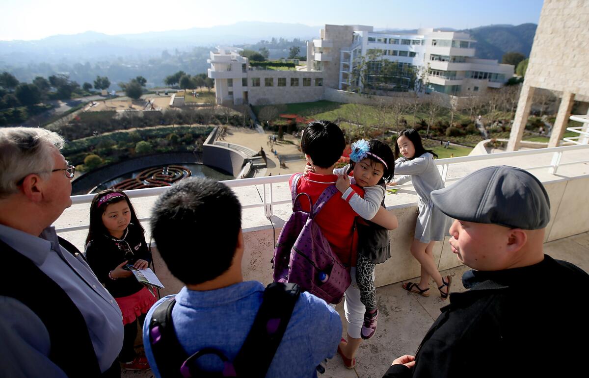 LOS ANGELES, CALIF. - FEB. 19, 2015. Tour operator Stanley Yu, right, talks with members of a Chinese tour group visiting the Getty Center in Brentwood on Tuesday, Feb. 17, 2015. Museums in Los Angeles are seeing an influx of tourists from the People's Republic of China as residents of that Asian economic powerhouse earn more for leisurely pursuits, including travel. Yu's business, Seagull Holiday, caters predominantly to visitors from mainland China. (Luis Sinco/Los Angeles Times)