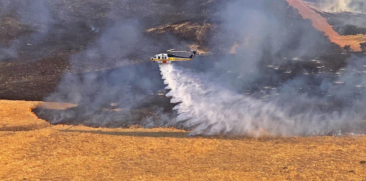 A helicopter drops water