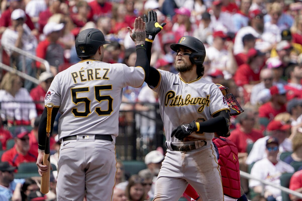 Pittsburgh Pirates' Michael Chavis, right, is congratulated by teammate Roberto Perez (55) after hitting a grand slam during the third inning of a baseball game against the St. Louis Cardinals Sunday, April 10, 2022, in St. Louis. (AP Photo/Jeff Roberson)