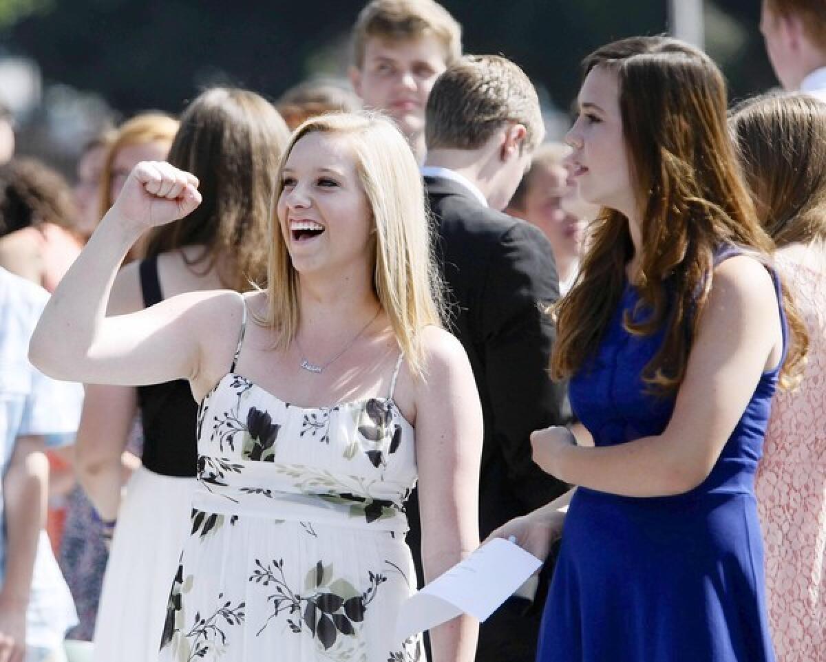 With friend Gracie Van de Voorde at her right, La Canada High School 7/8 8th grader Claire Swartzlander, left, pumps her fist at the crowd after receiving her promotion certificate during Promotion Program at the La Canada Flintridge school on Thursday, June 13, 2013.