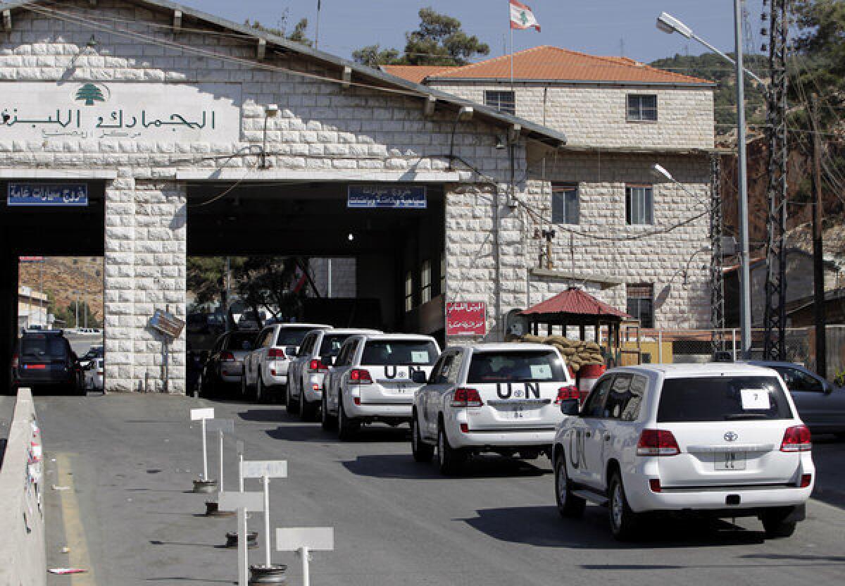A convoy of inspectors from the Organization for the Prohibition of Chemical Weapons prepares cross into Syria on Tuesday at the Lebanese border crossing at Masnaa, Lebanon.