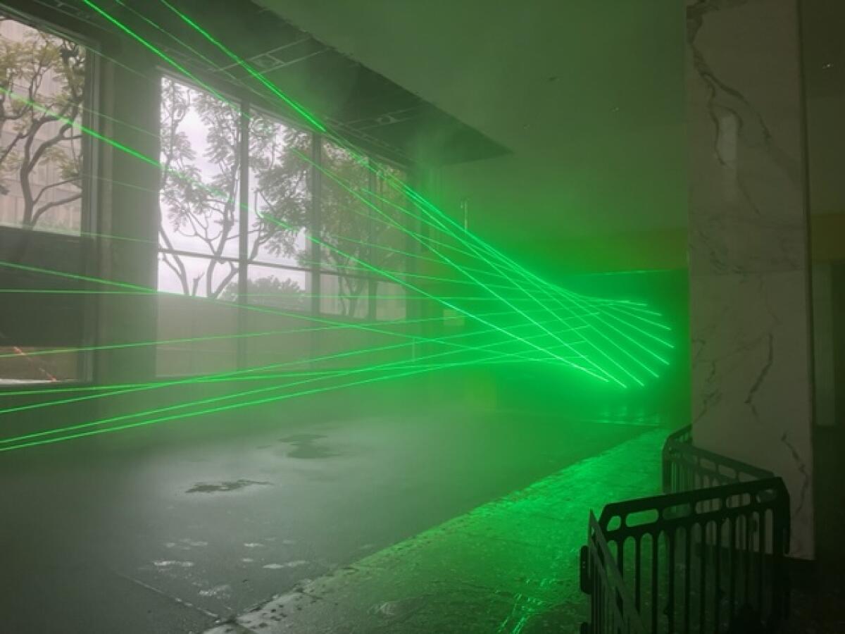 The laser installation by Rita McBride features neon green points of light