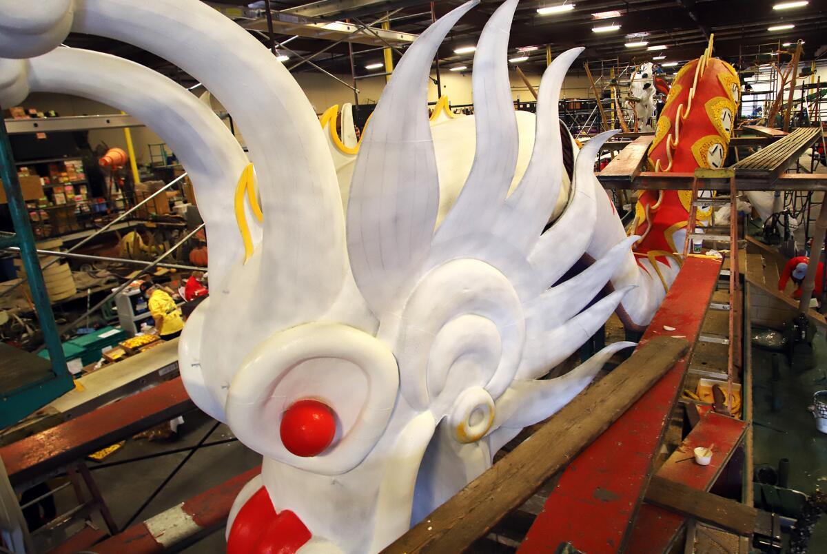 The cast of a Chinese dragon is ready to be flowered for Donate Life's "Lifting Each Other Up" float for the Rose Parade.