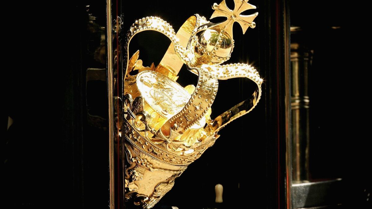 The ceremonial mace is seen protuding from a carraige window as it travels to The House of Lords for the state opening of Parliament.