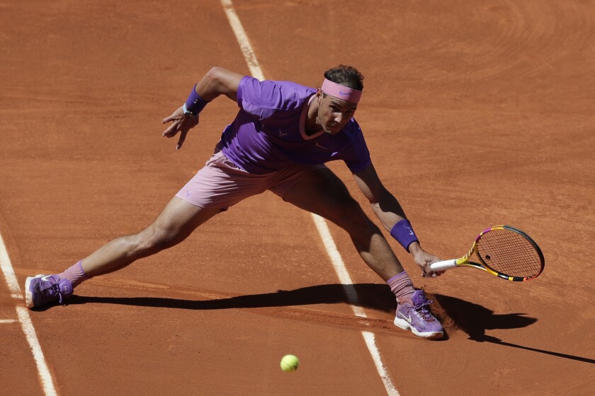 Rafael Nadal of Spain returns the ball to Alexei Popyrin of Australia during their match at the Madrid Open tennis tournament in Madrid, Spain, Thursday, May 6, 2021. (AP Photo/Paul White)