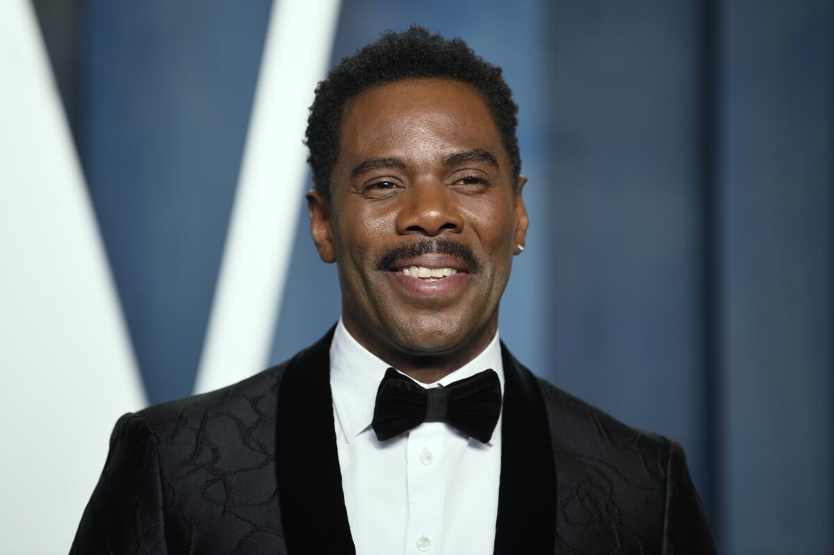 Colman Domingo wears a black patterned tuxedo and smiles.