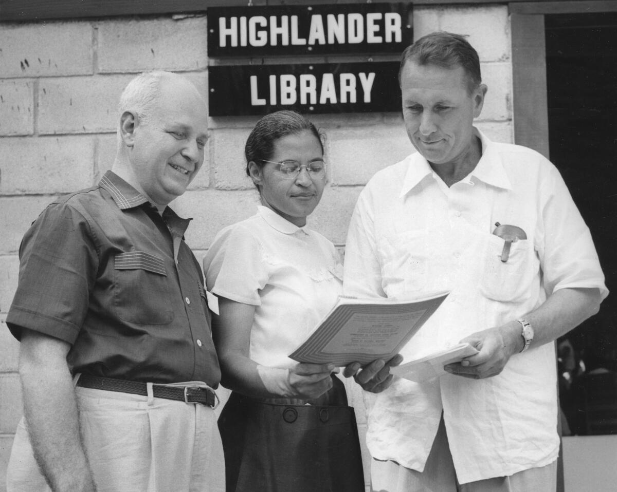 In this undated photo provided by the Nashville Banner Archives, Nashville Public Library, Special Collections, Rosa Parks, center, and Myles Horton, right, meet at the Highlander Library in Monteagle, Tenn. The library building where Rosa Parks, John Lewis and other civil rights leaders forged strategies that would change the world is mired in controversy over who gets to tell its story. (Nashville Banner Archives, Nashville Public Library, Special Collections via AP)