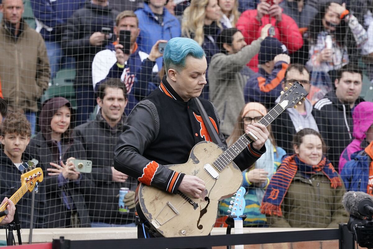 FILE - Musician Jack White performs the national anthem before the first inning of a baseball game between the Detroit Tigers and the Chicago White Sox, Friday, April 8, 2022, in Detroit. White surprised fans by marrying musician Olivia Jean on stage during his Detroit homecoming show Friday. The Detroit-born singer, songwriter and producer invited Jean onstage to join his performance and introduced her as his girlfriend. (AP Photo/Carlos Osorio, File)