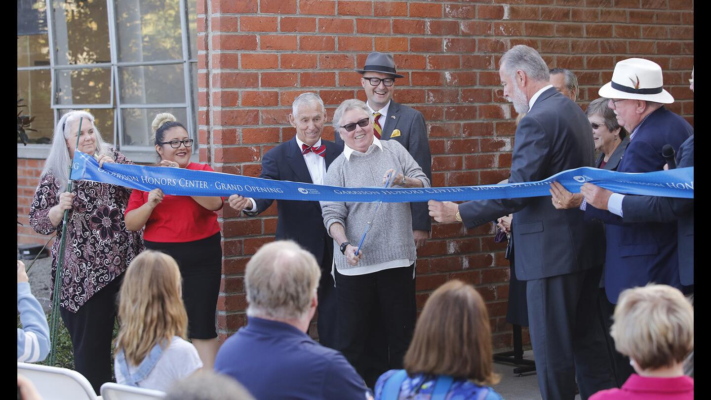 Marsha Garrison cuts the ribbon at the dedication of the renovated Garrison Honors Center, named after her late husband, Tom, on Wednesday at Orange Coast College in Costa Mesa.