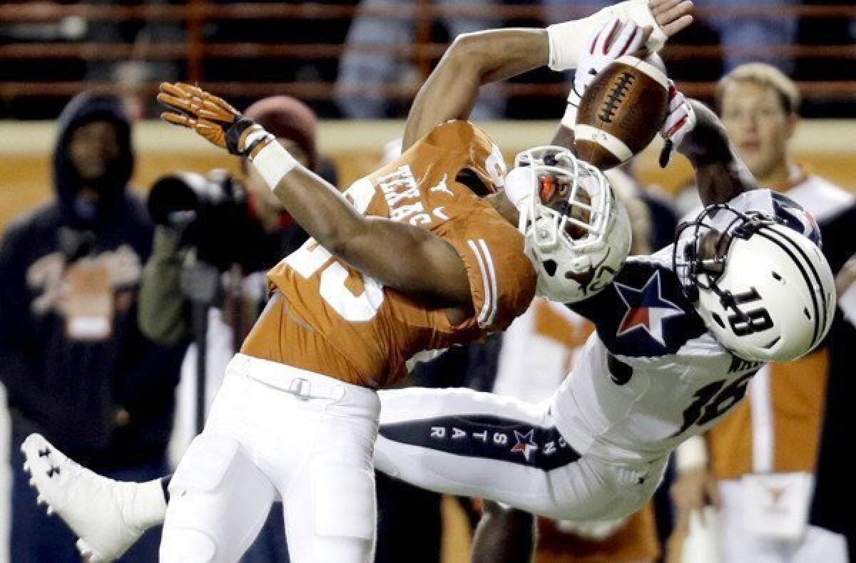 Texas defensive back Carrington Byndom deflects a pass intended for Texas Tech receiver Eric Ward (18) during the first half of their game Thursday night.