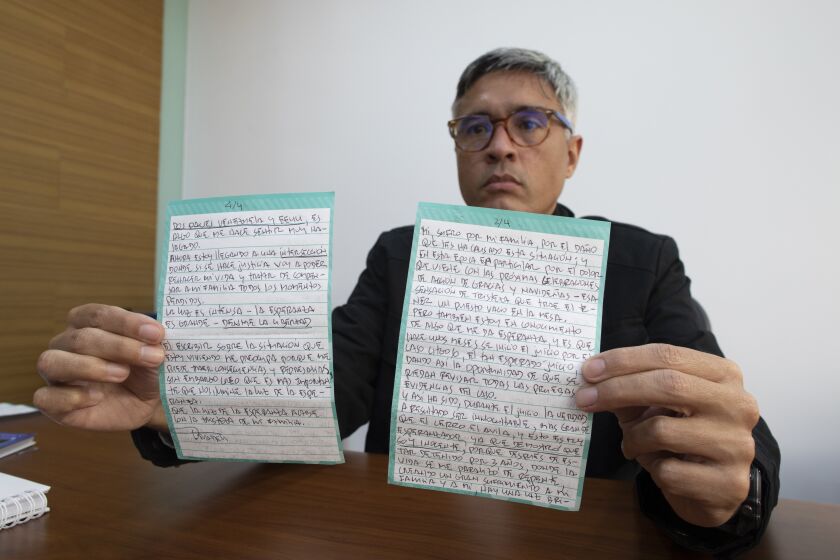 Jesus Loreto, an attorney representing Tomeu Vadell, one of six U.S. oil executives jailed for three years in Venezuela, shows a letter written by Vadell, in Caracas, Venezuela, Wednesday, Nov. 25, 2020. In the letter provided exclusively to The Associated Press on Tuesday, Nov. 24, 2020, Vadell pleads for freedom, reflects on his past and shares the pain he feels over being separated from his wife, three adult children and a newborn grandson he's never held. (AP Photo/Ariana Cubillos)