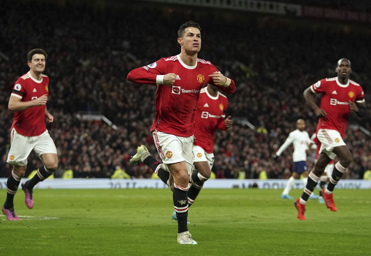 Manchester United's Cristiano Ronaldo, center, celebrates after scoring his third goal during the English Premier League soccer match between Manchester United and Tottenham Hotspur, at the Old Trafford stadium in Manchester, England, Saturday, March 12, 2022. (Martin Rickett/PA via AP)