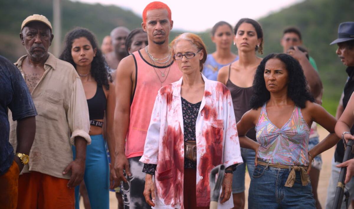 Sonia Braga, center, stands among a crowd wearing a bloodstained shirt in "Bacurau."