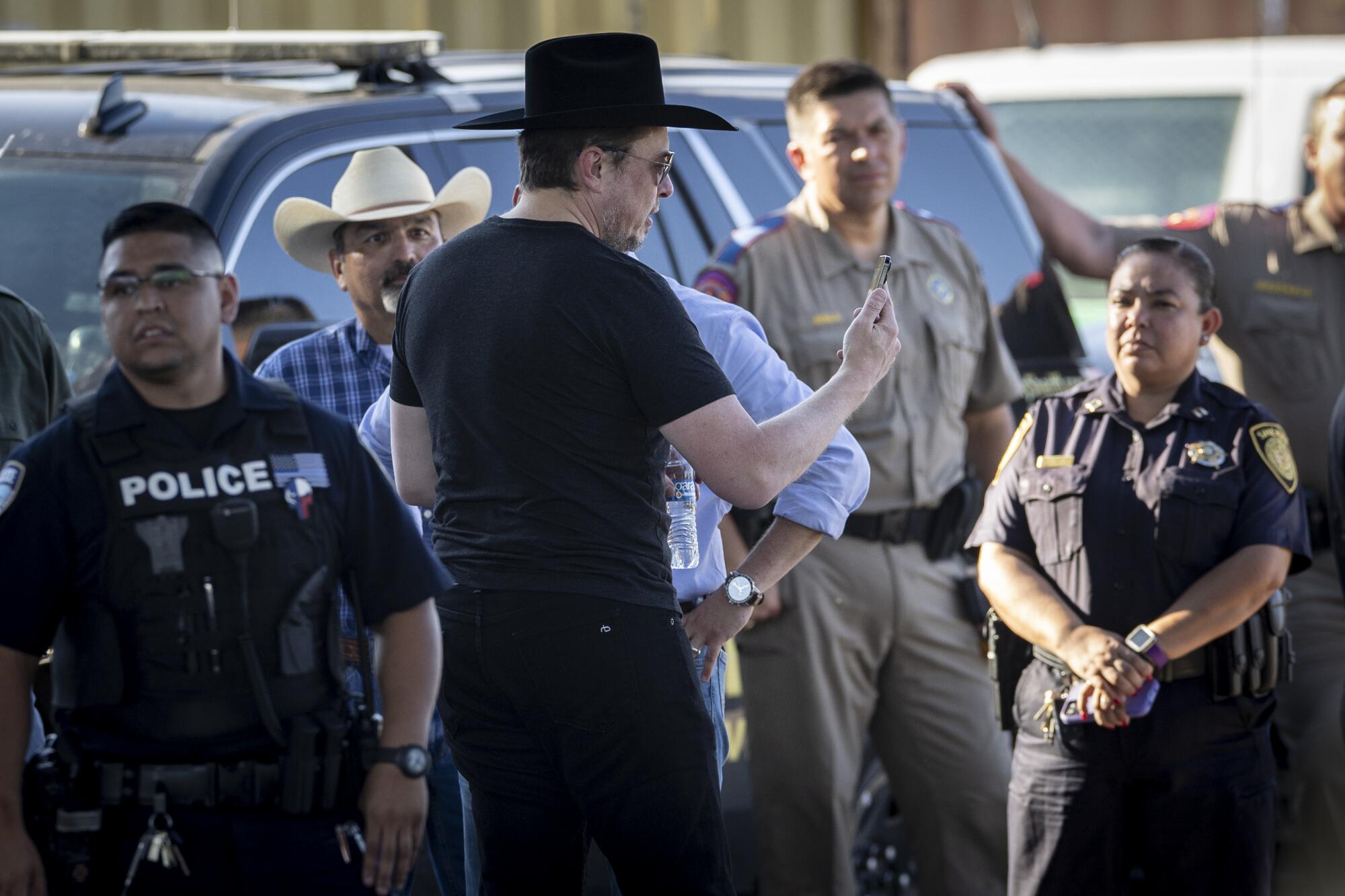 Elon Musk, wearing a black Stetson hat, livestreams while visiting the Texas-Mexico border.