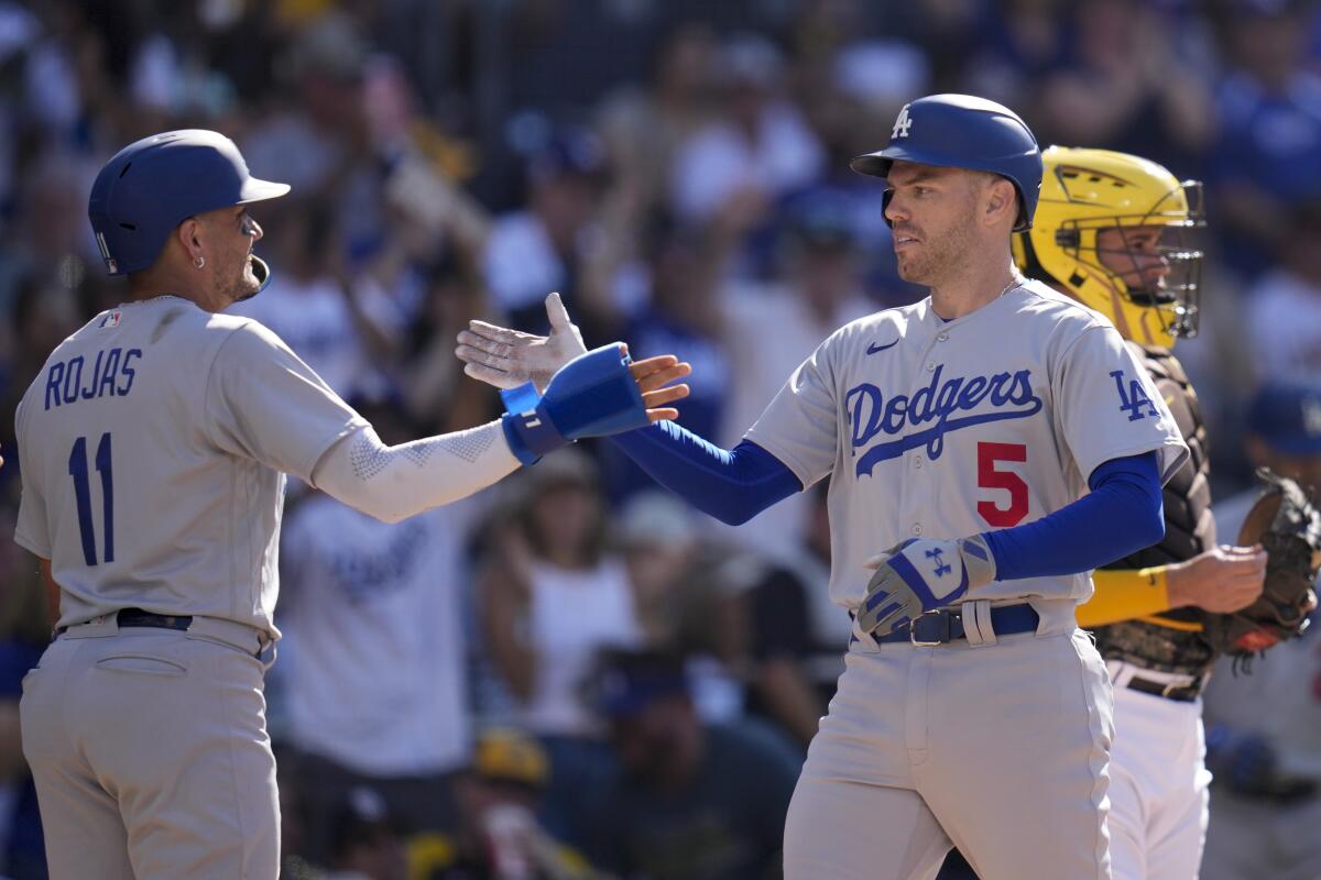 Freddie Freeman celebrates with Dodgers teammate Miguel Rojas.