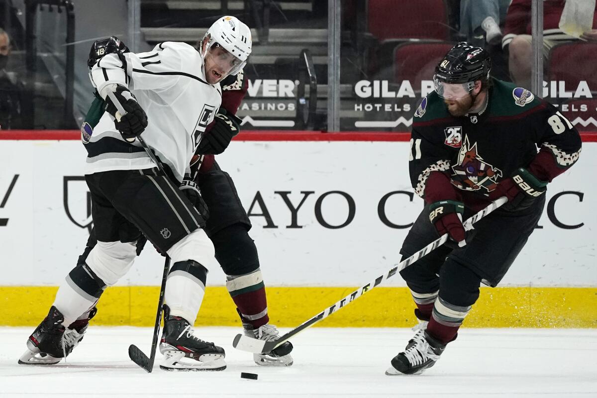 Arizona Coyotes right wing Phil Kessel takes the puck from Kings center Anze Kopitar.