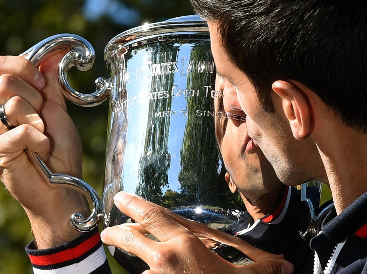 Novak Djokovic of Serbia kisses his championship trophy in Central Park in New York September 14, 2015 the morning after defeating Roger Federer of Switzerland to win the 2015 US Open Men's Singles Finals. AFP PHOTO / TIMOTHY A. CLARYTIMOTHY A. CLARY/AFP/Getty Images ** OUTS - ELSENT, FPG - OUTS * NM, PH, VA if sourced by CT, LA or MoD **