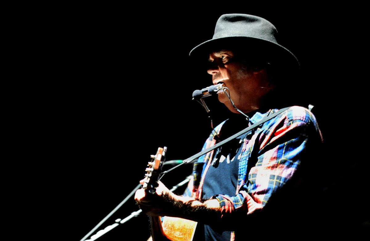 Neil Young performing in 2015 at the Forum in Inglewood. (Wally Skalij / Los Angeles Times)