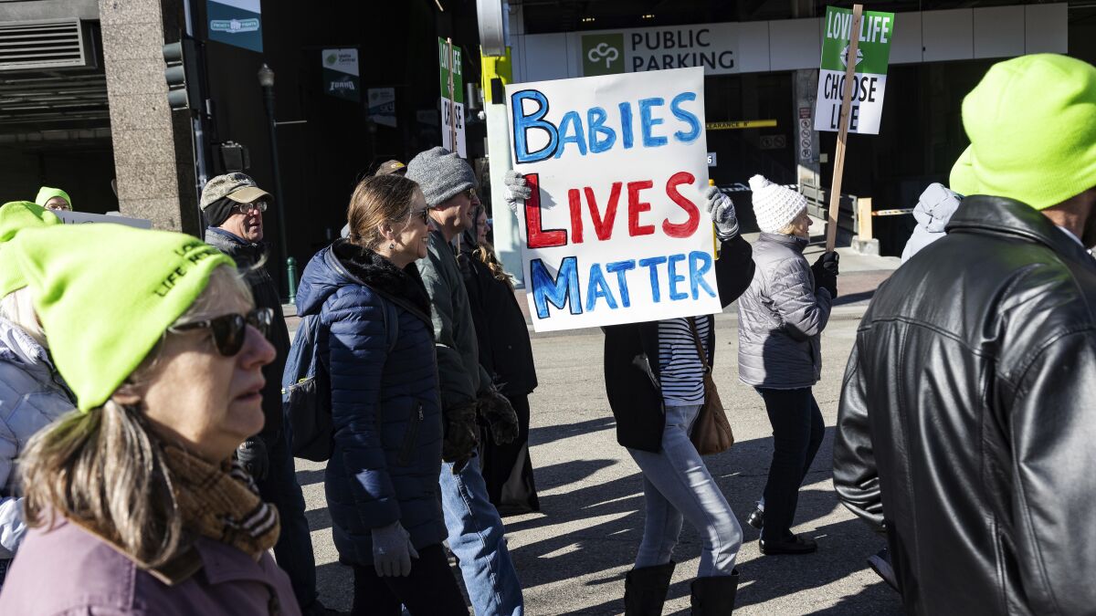 FILE - People walk to the Idaho Capitol Building for the Boise March for Life rally, Saturday, Jan. 21, 2023. A rural hospital in Sandpoint, Idaho, will stop delivering babies, citing recently passed state laws criminalizing medical care, among other reasons. (Sarah A. Miller/Idaho Statesman via AP,File)
