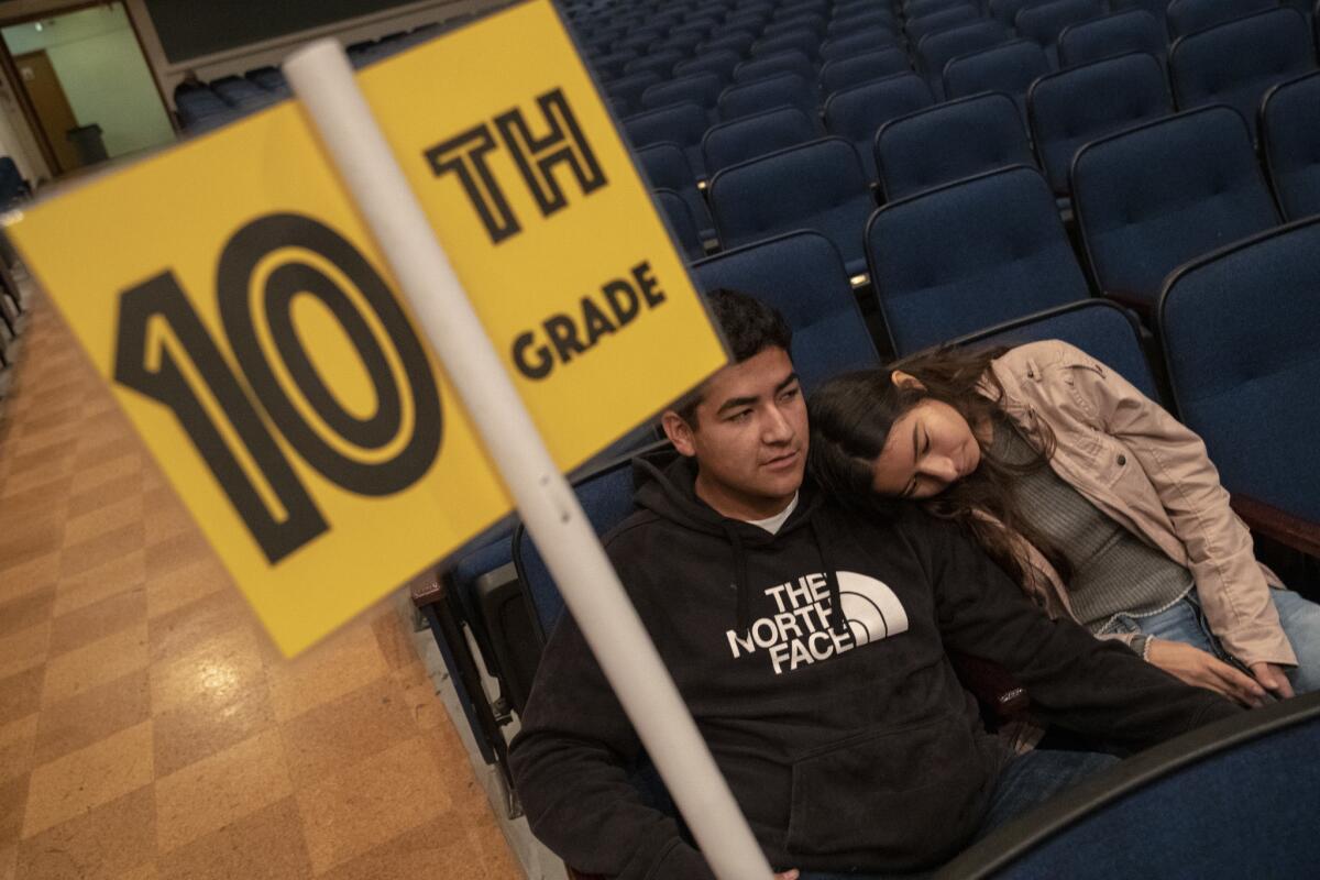 Reseda High students Roosevelt Jimenez, 17, left, and friend Kimberly Aquino, 17, right, sit in the school auditorium as UTLA teachers are out on strike in Reseda.