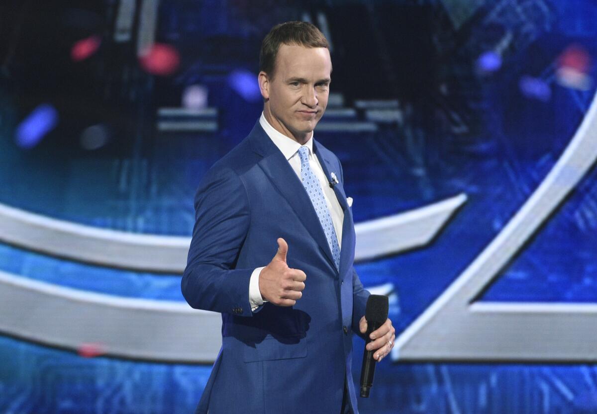 Peyton Manning gives a thumbs up as he delivers some sharp one-liners while hosting the ESPY Awards in 2017.