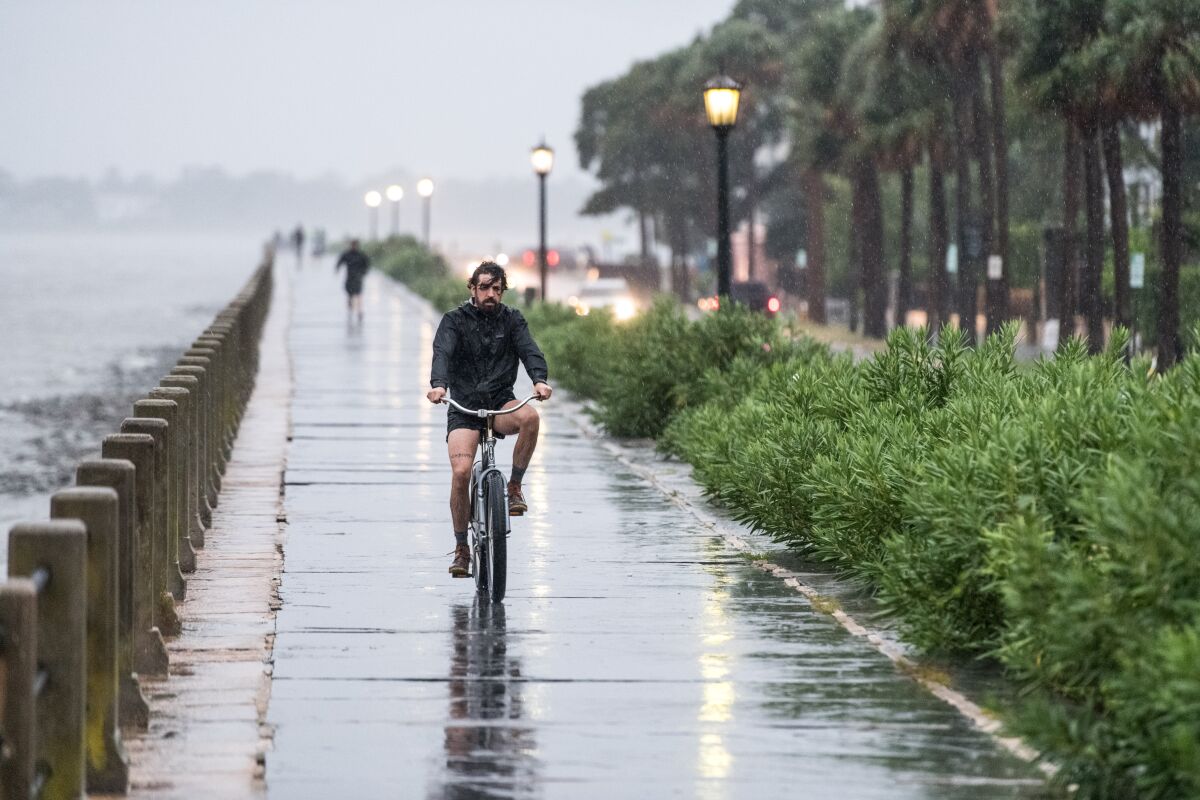 A man rides a bicycle along the Battery in Charleston, S.C.