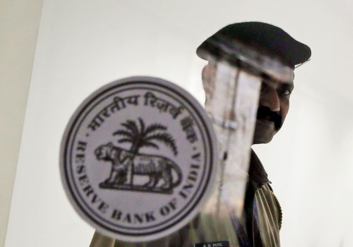 FILE- A security guard stands at the entrance of the Reserve Bank of India in Mumbai, India, Oct. 4, 2019.India’s central bank on Wednesday raised its key interest rate to 4.9% from 4.4%, a second such hike in the last three weeks aimed at containing fast-rising inflation. (AP Photo/Rajanish Kakade, File)