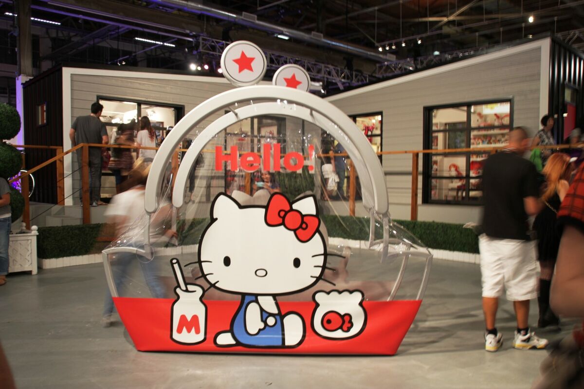 Hello Kitty Con opened in downtown Los Angeles on Thursday to very long lines and extravagant ensembles. An oversized replica of the original Hello Kitty coin purse decorates the convention floor.