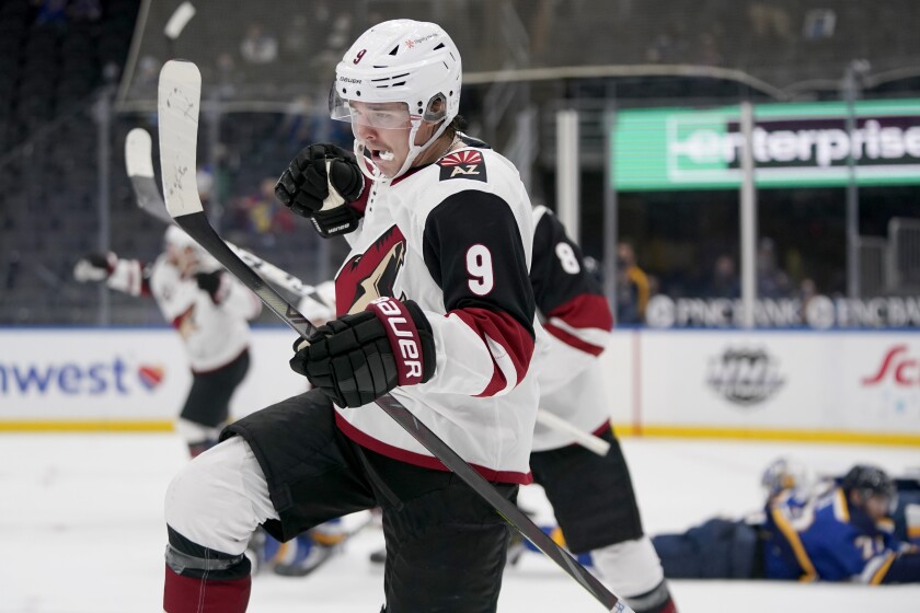 Arizona Coyotes' Clayton Keller (9) celebrates after scoring with less than a second left during the third period of to tie an NHL hockey game against the St. Louis Blues Monday, Feb. 8, 2021, in St. Louis. The Coyotes won in a shootout. (AP Photo/Jeff Roberson)