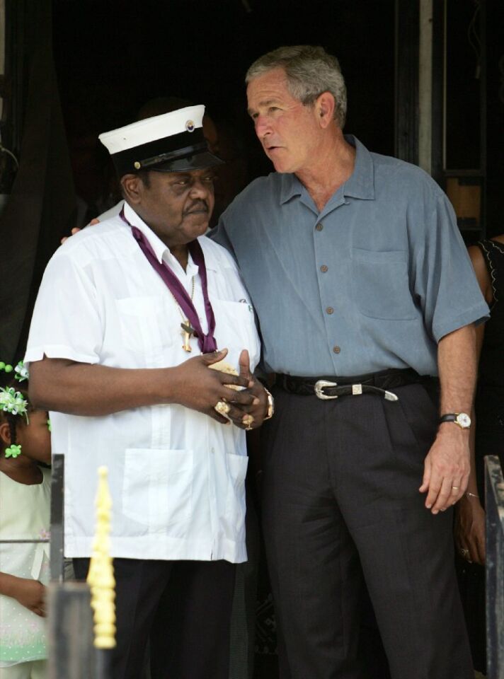 Then-President George W. Bush talks with Fats Domino, left, in New Orleans' Lower Ninth Ward of New Orleans in August 2006 to commemorate the first anniversary of Hurricane Katrina.
