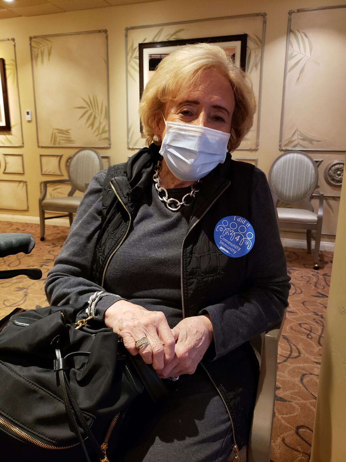 Chateau La Jolla resident Judy Chamberlain sports a sticker after getting her COVID-19 vaccination.
