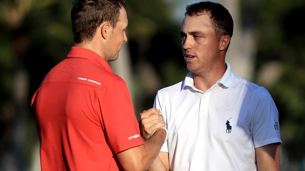 Justin Thomas, right, is congratulated by Jordan Spieth after finishing the second round of the Sony Open on Friday.