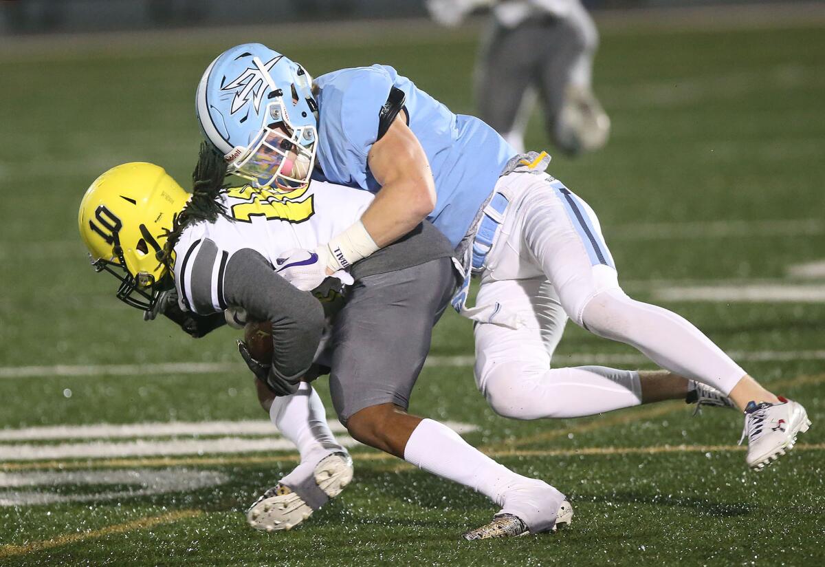 Corona del Mar's Chandler Fincher, right, takes down Cajon's BJ Phillips in the quarterfinals of the CIF Southern Section Division 3 playoffs on Nov. 16 at Newport Harbor High.