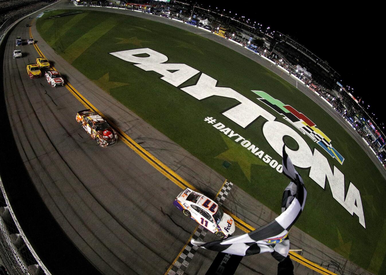 NASCAR driver Denny Hamlin crosses the finish line to win the Daytona 500.