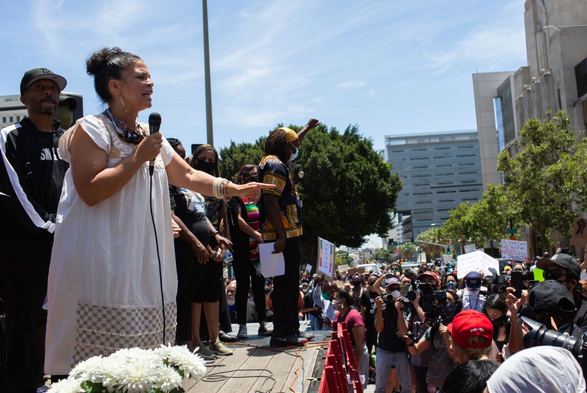 Melina Abdullah speaks from a stage at a George Floyd protest in downtown Los Angeles