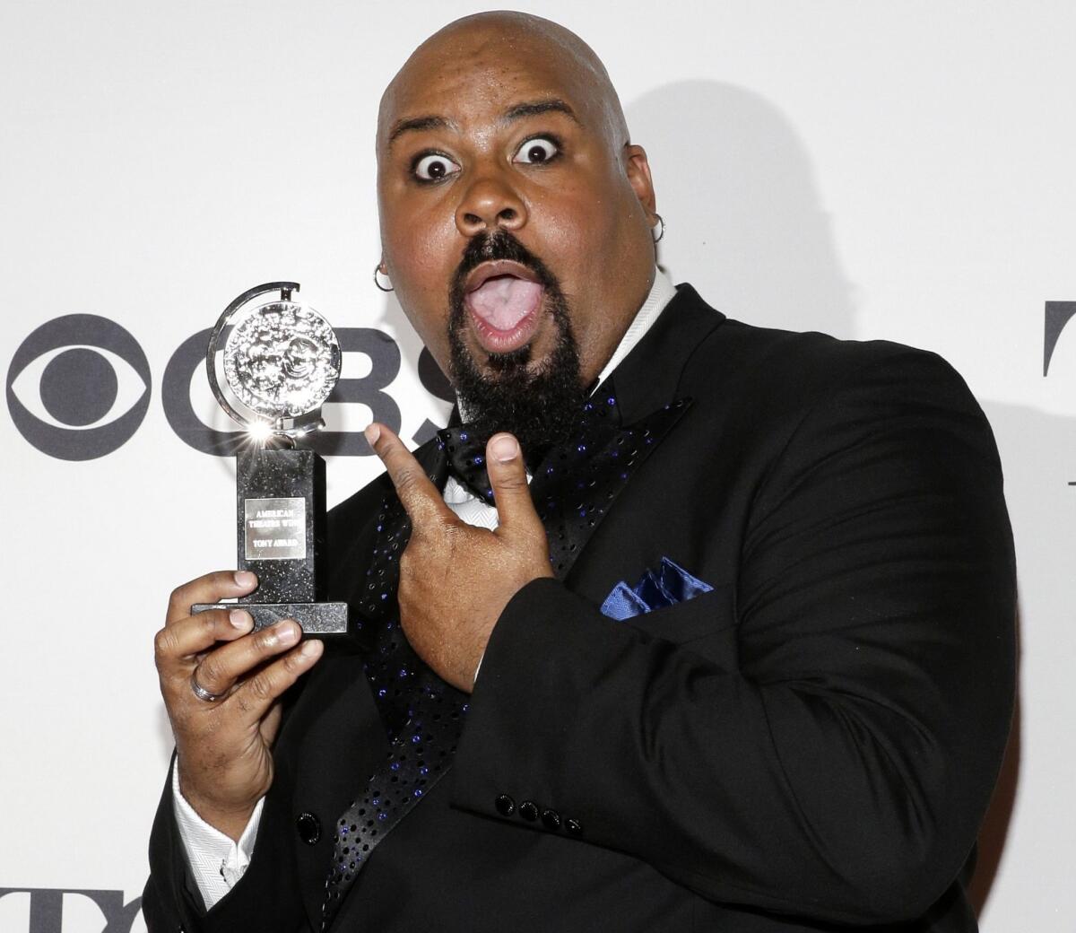 James Monroe Iglehart, who played the genie in the Broadway version of Disney's "Aladdin," holds his Tony Award for actor in a featured role in a musical.