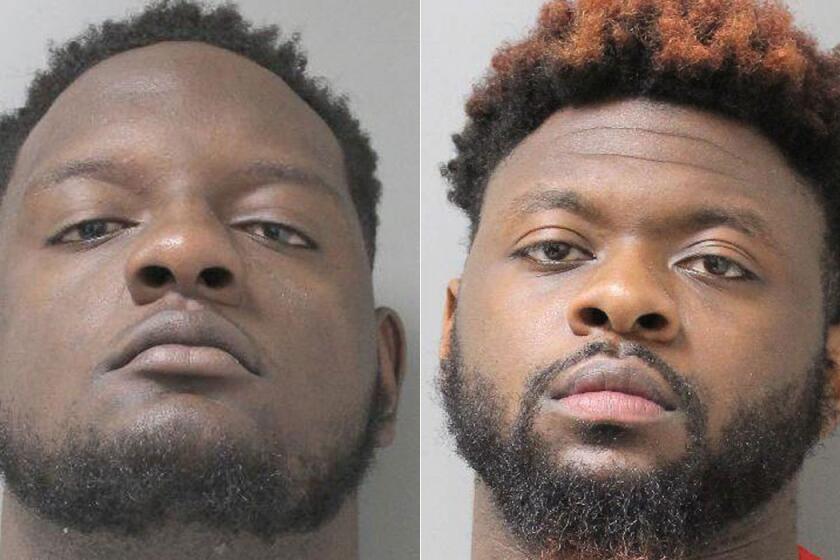 Booking photos of Alabama teammates Cam Robinson, left, and Laurence Jones, who were arrested on May 17.