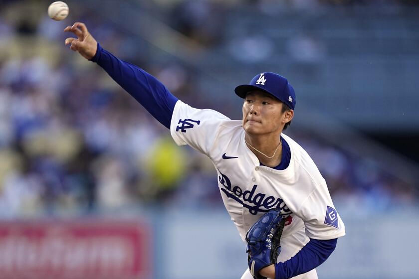 Dodgers starting pitcher Yoshinobu Yamamoto delivers during the first inning at Dodger Stadium.