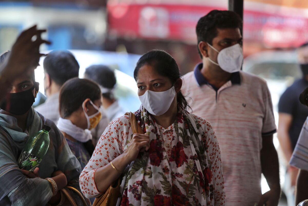 Indians wearing face masks wait for medical check-up outside a government hospital in Jammu, India, Wednesday, Sept.9, 2020. India's coronavirus cases are now the second-highest in the world and only behind the United States. (AP Photo/Channi Anand)