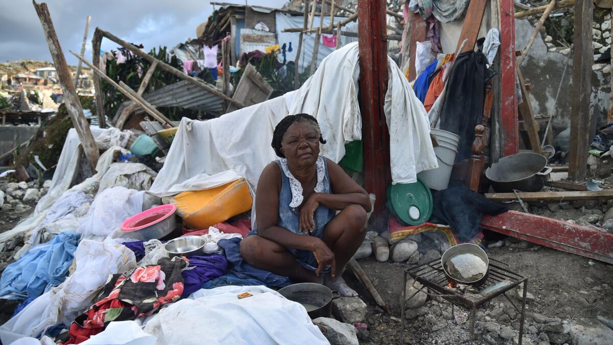 A woman sits in her home destroyed by Hurricane Matthew in Jeremie, western Haiti.