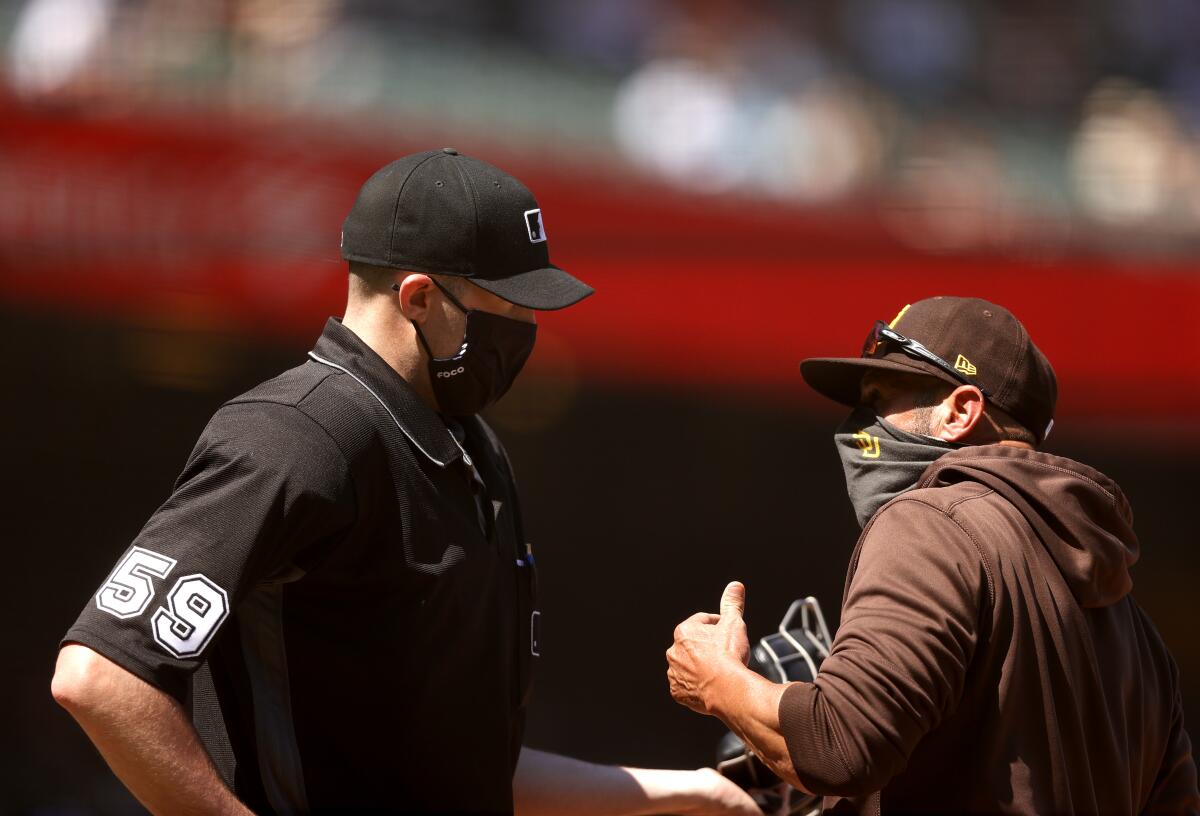 Padres manager Jayce Tingler talks with umpire Nic Lentz after being ejected 