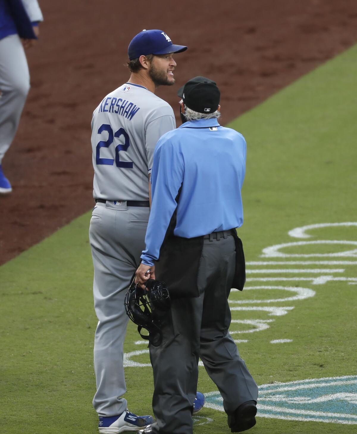 Dodgers pitcher Clayton Kershaw argues a catcher interference call in the fourth inning against the Padres.