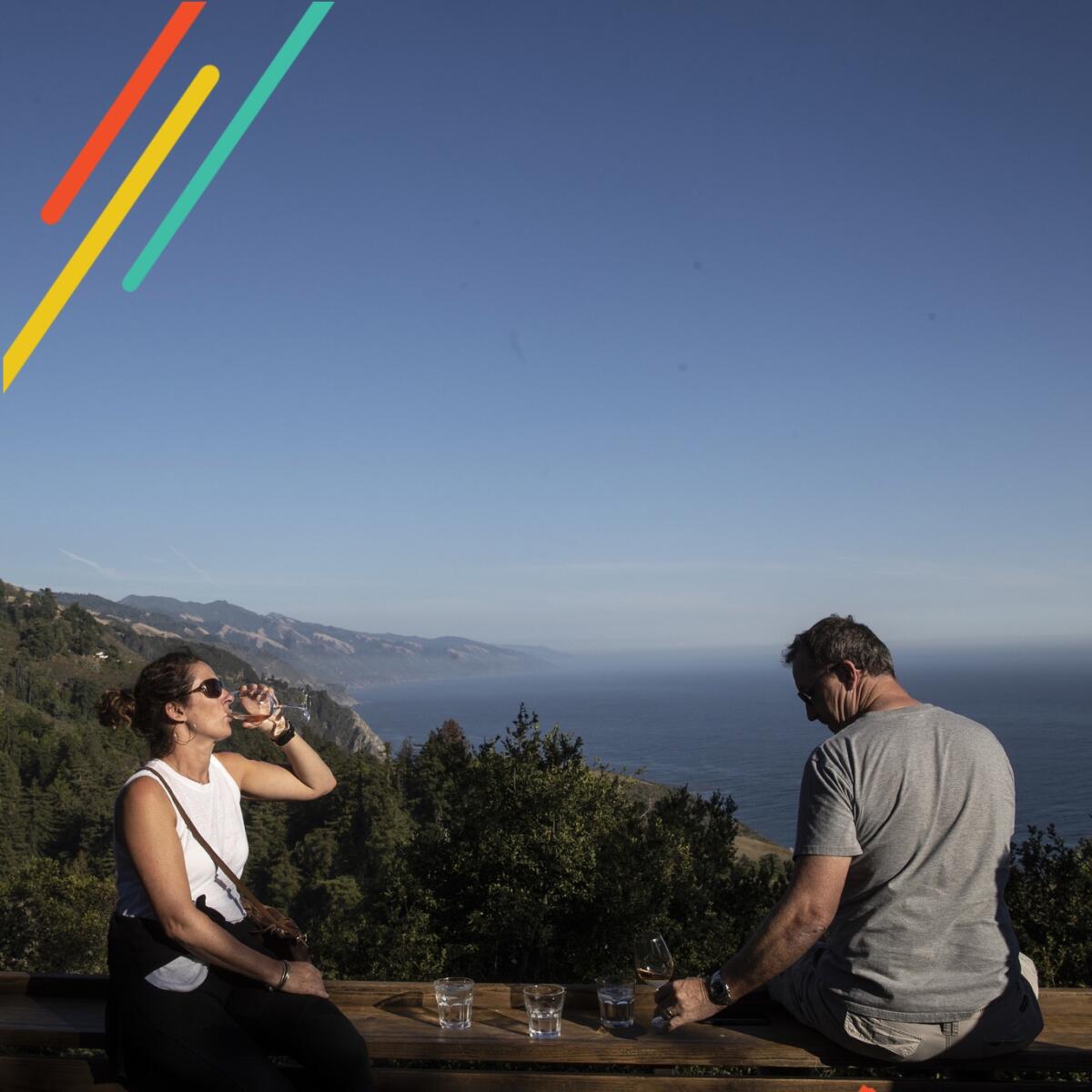 A man and a woman enjoy cocktails at Nepenthe on the Big Sur coast.