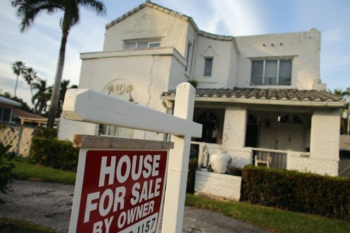 A 'For Sale' sign is posted in front of a house in Hollywood, Fla., in November.