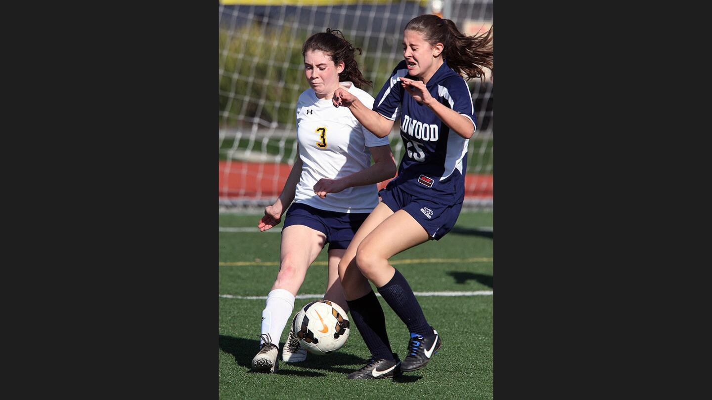 St. Monica Academy's Riley O'Brien clears the ball with Wildwood's Jordan Fenster attacking in front of the St. Monica Academy goal in a CIF Southern Section Division VII wildcard girls' soccer match at the Glendale Sports Complex on Tuesday, February 14, 2017. St. Monica Academy lost the game 1-0.
